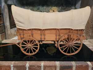 Horse drawn covered wagon.